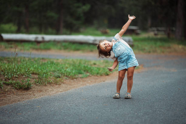 Autumn colours. Beautiful woman in coat posing in forest on roadside