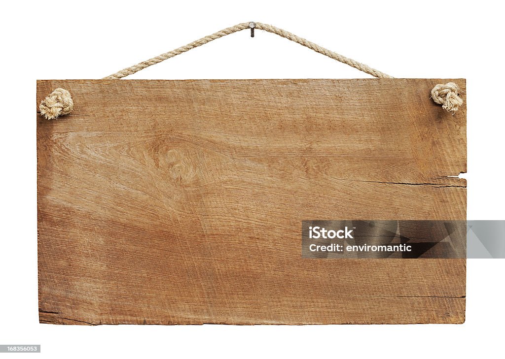 Old weathered wood signboard background. Old weathered wood sign background, hanging by old rope from a nail, isolated on white, clipping path included. Wood - Material Stock Photo