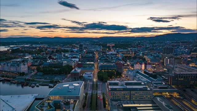 Aerial view of modern urban borough at Central train station and futuristic design Opera House at harbour. Hyperlapse footage of metropolis at sunset. Oslo, Norway