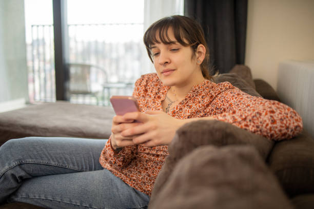 istock Happy young woman using phone 1683581617