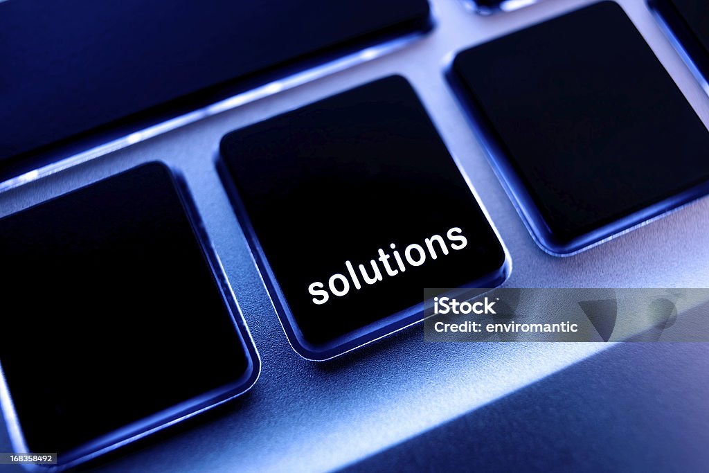 Computer laptop keypad 'solutions' button. Shallow depth of focus, focus is through the 'solutions' word on the keypad button. Laptop Stock Photo