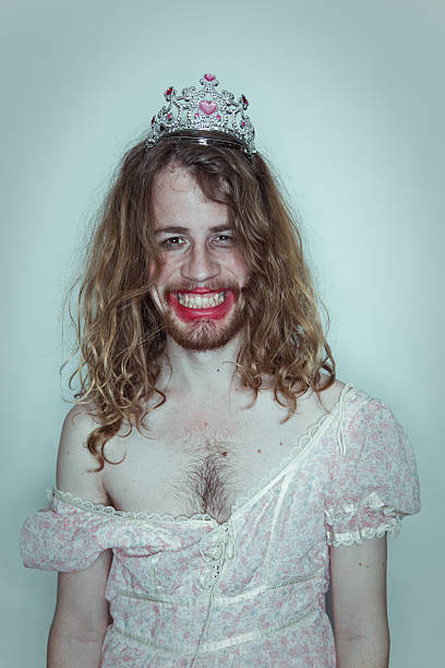 Happy Male Prom queen in drag tiara on head lipstick A fine photo shot ring light style of a long haired male happy as can be with make-up smeared on face.   Funny drag queen photo. Smiling Man. prom photos stock pictures, royalty-free photos & images