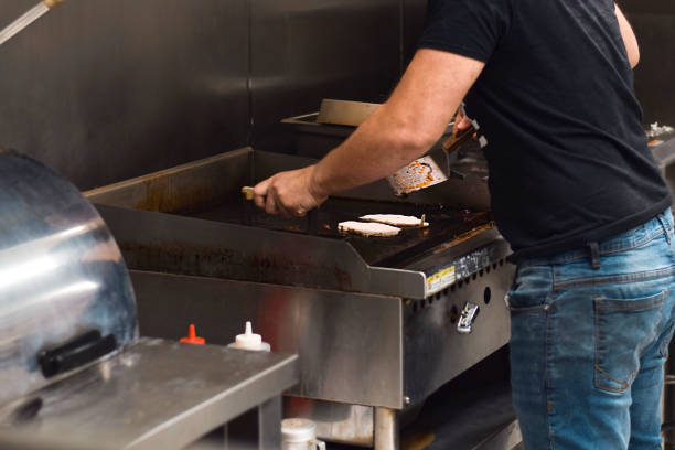 istock Restaurant employee preparing food on a grill 1683602345