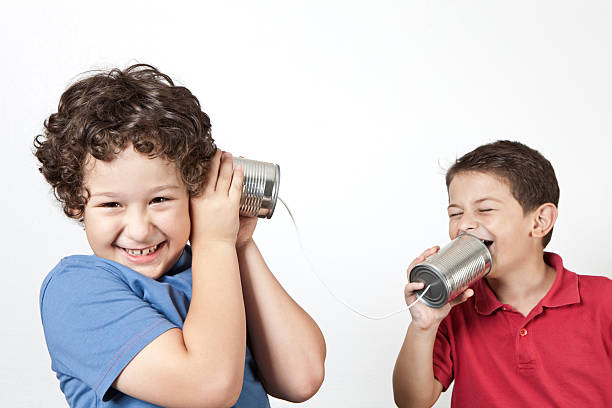 istock Two happy young boys using tin cans and a string as a phone 168365268