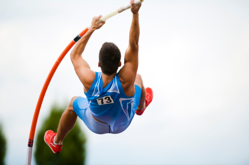 Front view of young male athlete at the first phase of the jump