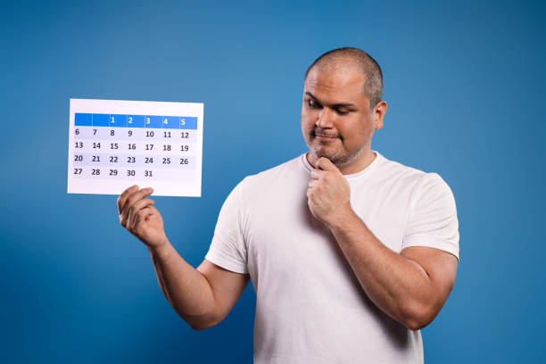 istock man holding calendar and looking at it 1683683837