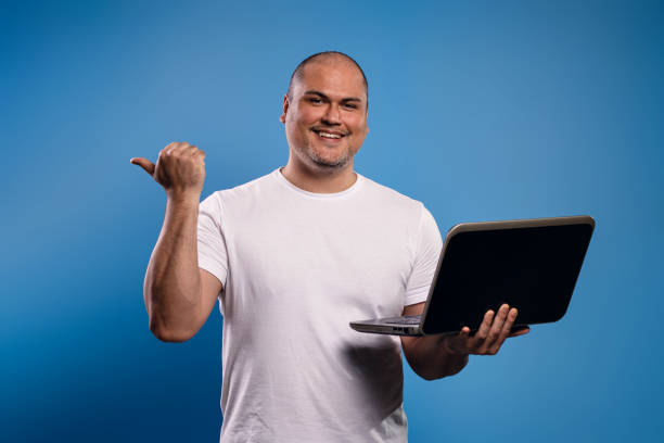 istock man holding a notebook and pointing to the side 1683684374