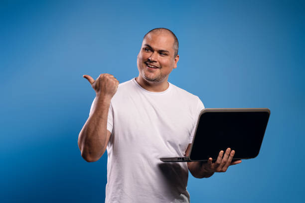 istock man holding a notebook and pointing to the side 1683684383