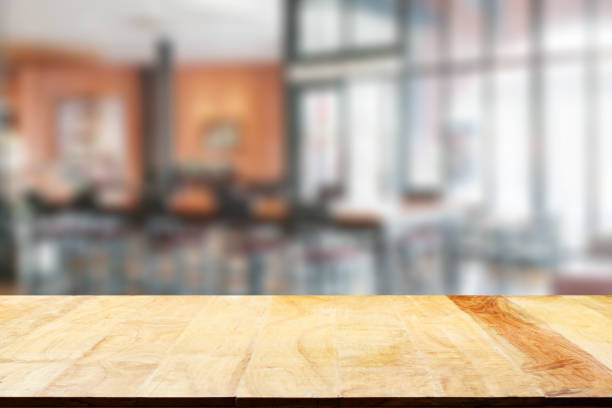 istock Empty wooden table and blurred cafe background, product display 1683718489