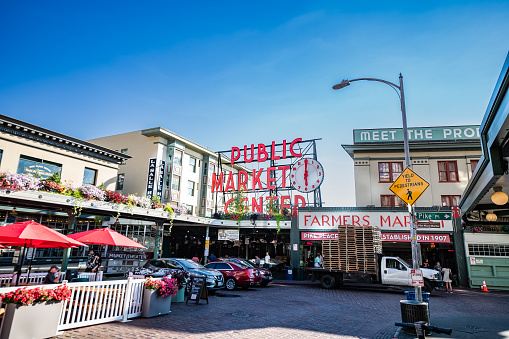 Pike Place Market as seen from Pike street on the sidewalk in Seattle, Washington on a clear sunny summer day