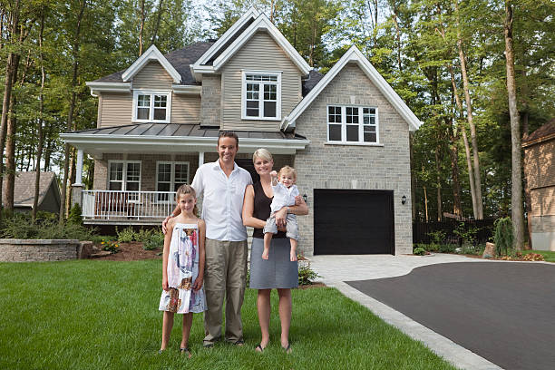 Happy Family With Key Of Their New House stock photo