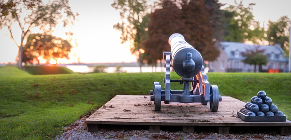 A vintage cannon and cannonballs