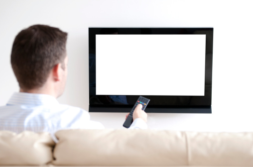 Man sits in sofa watching tv. He is pointing a remote at the tv. White screen: insert your own image easily.