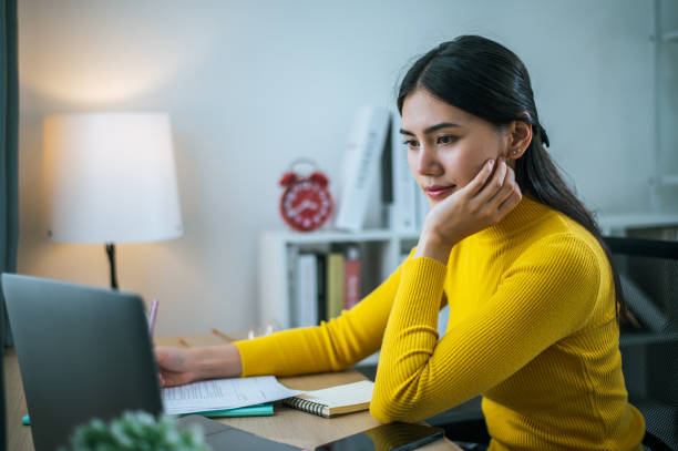 istock Young woman working with laptop computer at home 1683805794