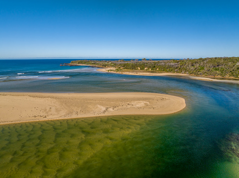 Blue sky daytime coast views over the sea and the Wallagaraugh River at Mallacoota, Victoria, Australia