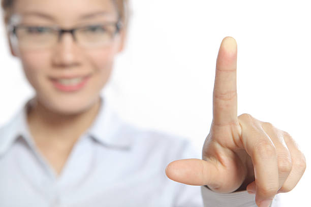 businesswomen on white background is touching on glass. Focused at the finger!
