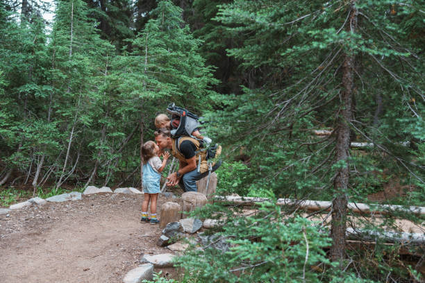 istock Loving father affectionately kisses young daughter while hiking 1683860722