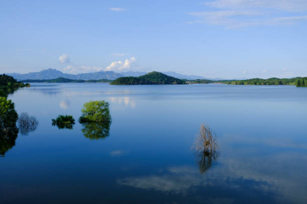 istock white clouds,blue sky,blue lake,green plants and green mountains. 1683896437