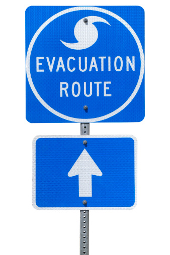 An isolated Directional Sign indicating the Storm Evacuation Route with arrow pointing straight ahead. Image include clipping path.