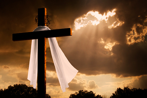 This dramatic lighting with storm clouds breaking and sunshine bursting through makes a great Easter photo illustration of Jesus dying on the cross and rising again.