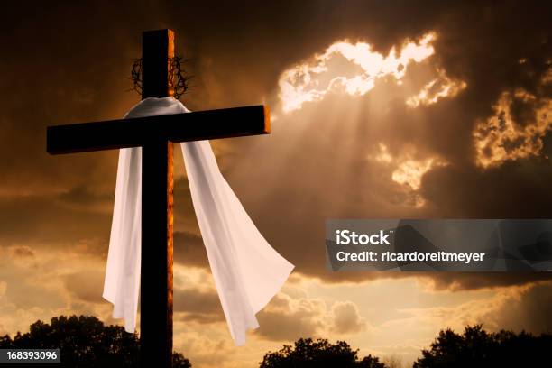 Dramatic Lighting On Christian Easter Cross As Storm Clouds Break Stock Photo - Download Image Now