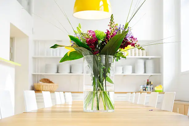Photo of Flowers on table in bright large kitchen