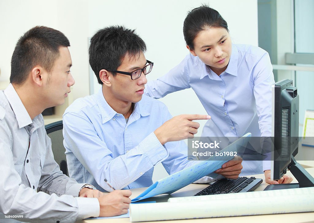 business team discussion in the office small business team discussion in front of computer in office. 25-29 Years Stock Photo