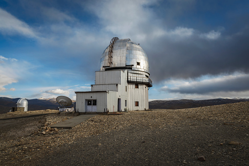Indian Astronomical Centre in Hanle stands tall against a backdrop of a vivid blue sky adorned with fluffy white clouds