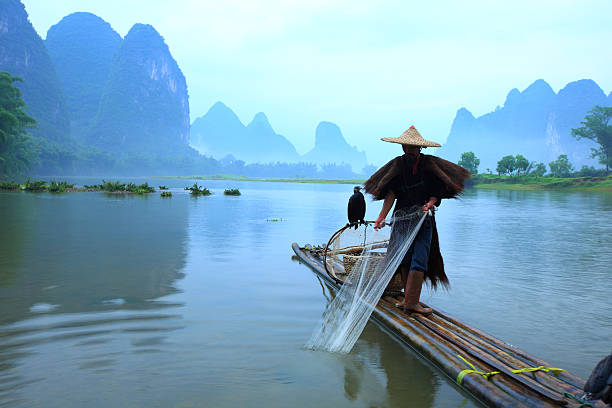 istock Man standing on bamboo planks with fishing net 168404689