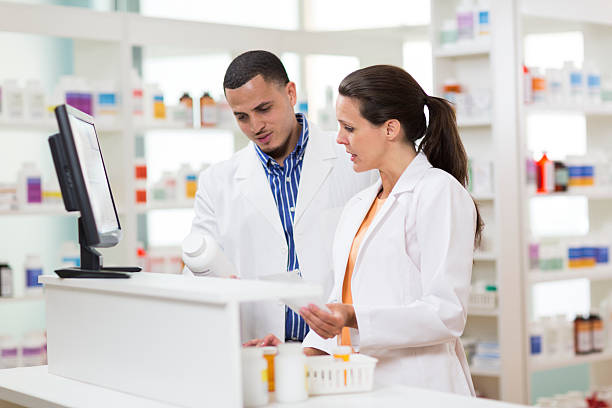 istock Two Pharmacists filling Prescription 168409990