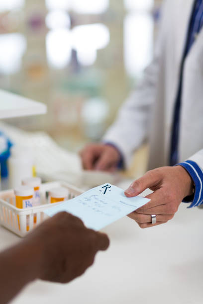 istock Customer Giving RX Prescription to Pharmacist 168409993