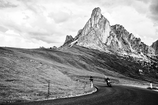 Bikers Riding on Giau Pass Mountain Road, Dolomites, European Alps.