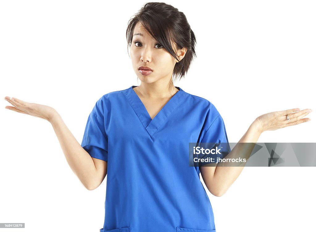 Young Asian Nurse in Blue Scrubs Shrugging Young Asian female nurse in blue scrubs, shrugging with hands in the air as if uncertain or confused; isolated on white. Nurse Stock Photo