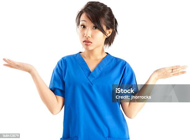 Young Asian Nurse In Blue Scrubs Shrugging Stock Photo - Download Image Now - Nurse, Confusion, White Background