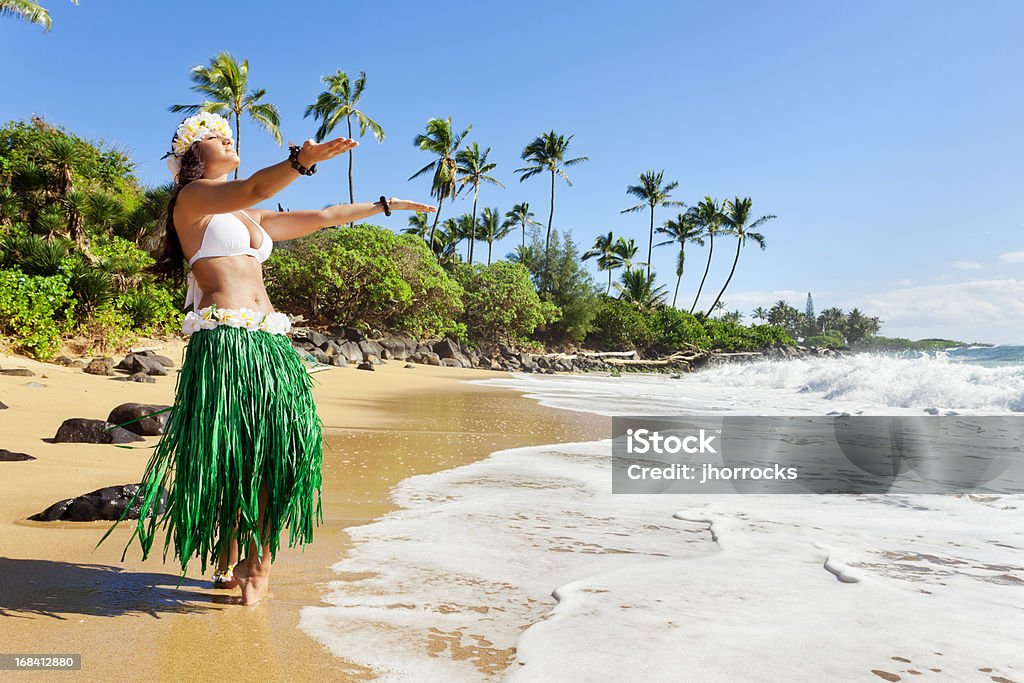 Hula Dancer on Beach Attractive young hula dancer, dancing on a Hawaiian beach with arms stretched out toward the sea. Big Island - Hawaii Islands Stock Photo