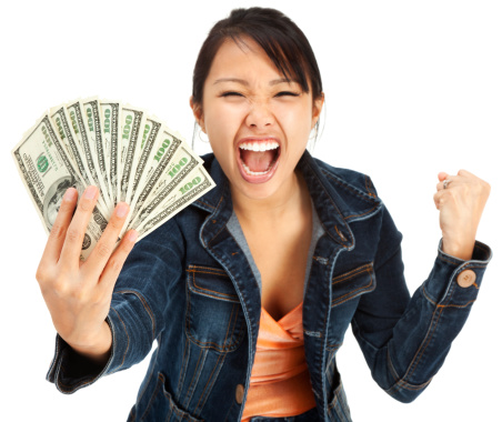 Photo of a smiling young woman with a fan of ten U.S. 100 dollar bills (cash) in her hands; isolated on white. $1000