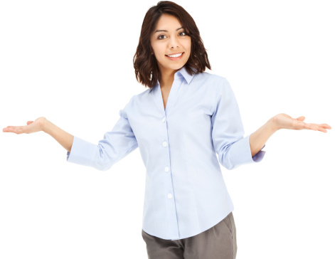 Photo of an attractive young Hispanic businesswoman in blue button-down shirt, shrugging with hands out; isolated on white.