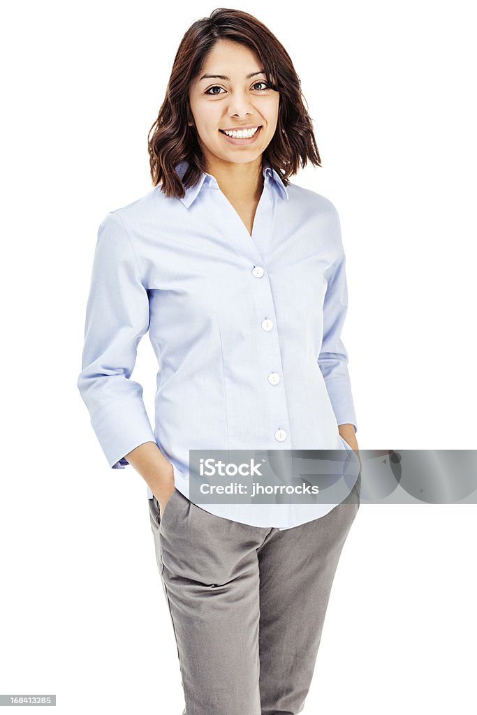 Attractive Young Hispanic Businesswoman Photo of an attractive young Hispanic businesswoman in blue button-down shirt, standing with hands in pockets; isolated on white. Women Stock Photo