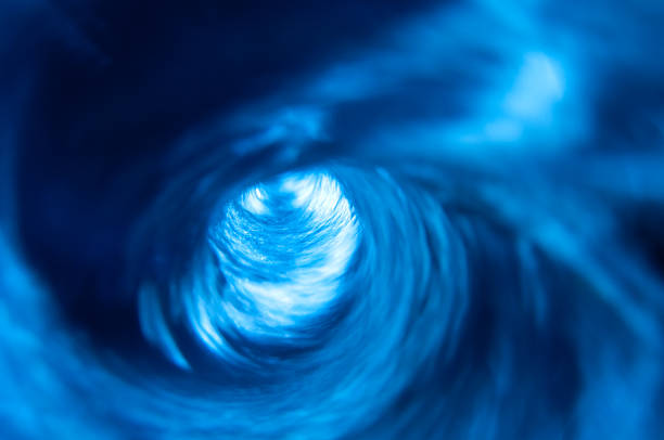 Swirling Blue Water Vortex Swirling blue water vortex. flushing water stock pictures, royalty-free photos & images