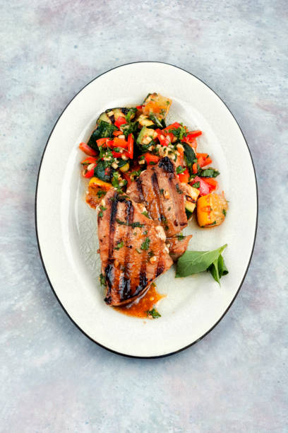 Tuna steak fried with grilled vegetables. stock photo
