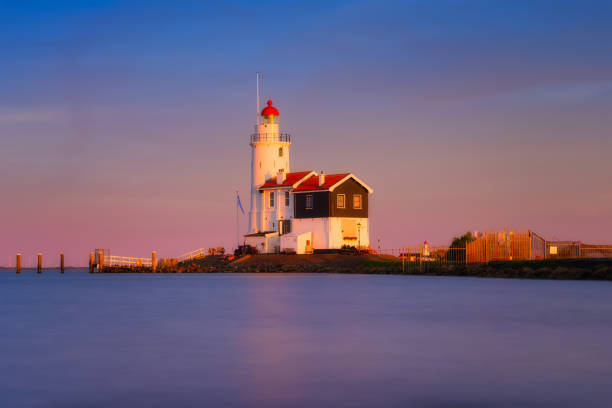 istock A lighthouse on the beach during sunset. A landmark in maritime navigation. Long exposure. Natural composition. Photo for wallpaper and background. Paard van Marken, Netherlands. 1684148442