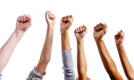 Multiracial clenched fists raised in the air could signify approval or defiance. Isolated against a white background. 