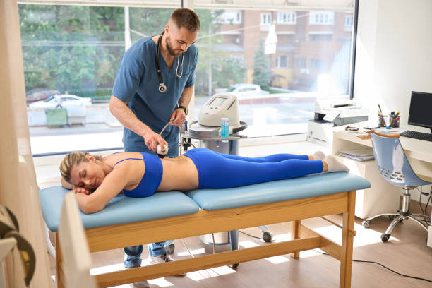 istock Rehabiliotology specialist using extracorporeal shock wave therapy 1684199439
