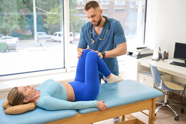 istock Man orthopedist checking female patient joints and kneecaps 1684201623