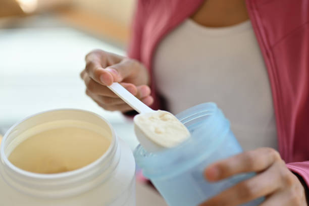 istock woman preparing whey protein after workout at home 1684205966