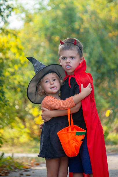 istock Children dressed in costumes for Halloween, festive night. Selective focus 1684210327