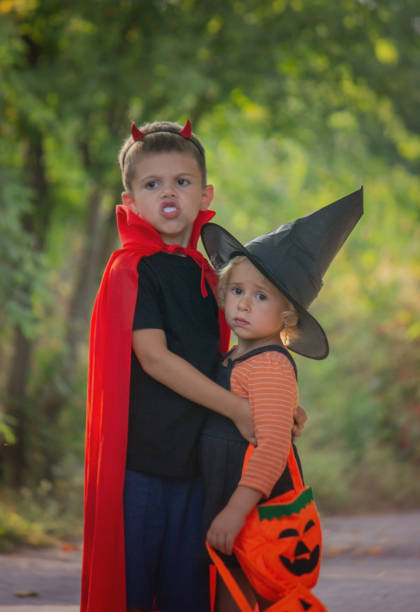 istock Children dressed in costumes for Halloween, festive night. Selective focus 1684210344