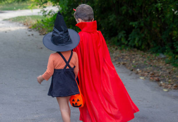 istock Children dressed in costumes for Halloween, festive night. Selective focus 1684210873