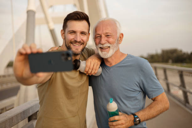 istock Athletic Son and Senior Father Taking a Selfie 1684214141