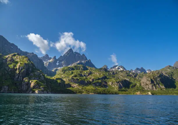 Photo of The Trollfjord or Trollfjorden, Hadsel, Lofoten Islands, Nordland, Norway. The  fjord is only accessible by boat and it is famous for its narrow entrance and steep-sided mountains surrounding it